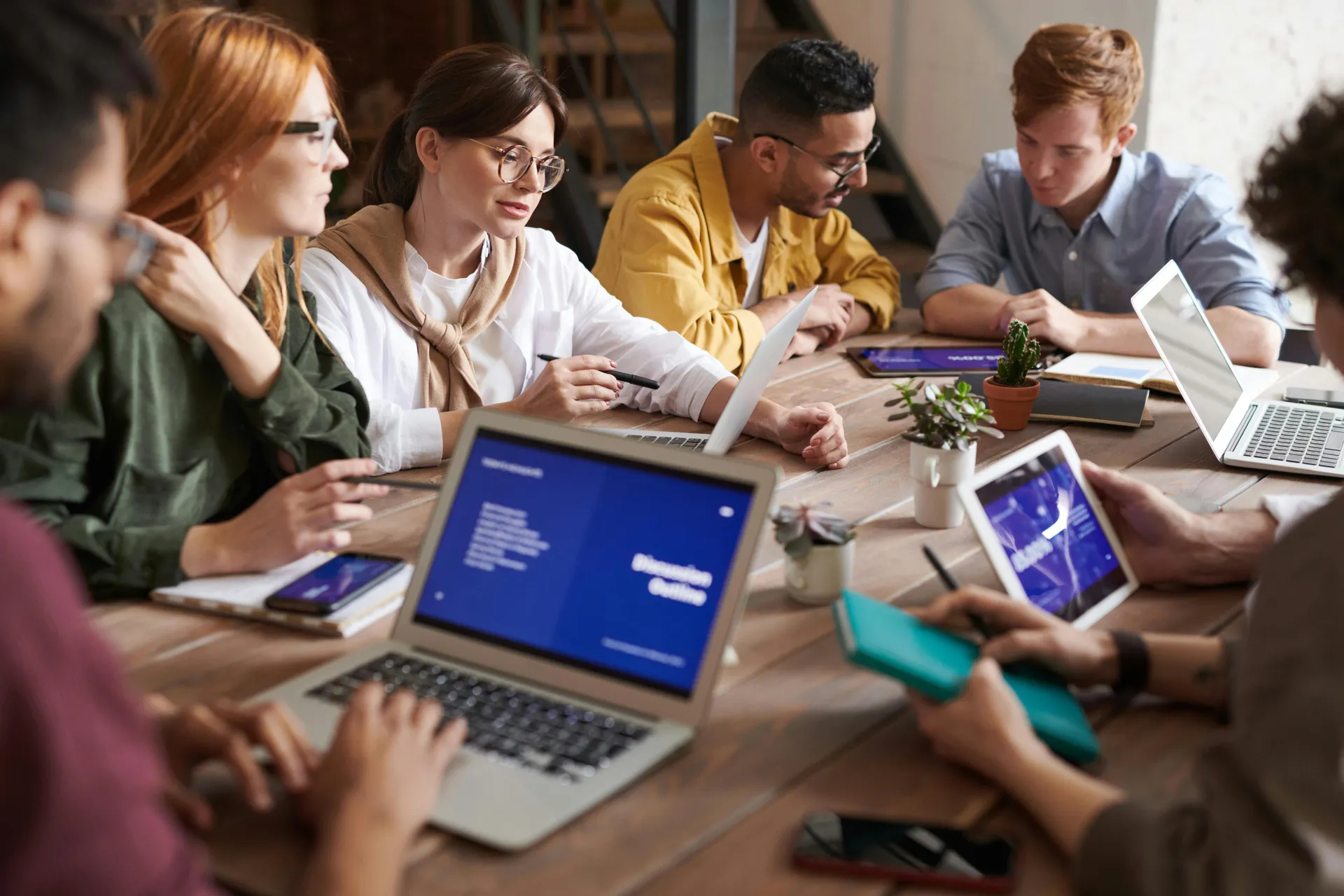 Team of business professionals collaborating in a modern office, representing the people and values behind StratEdge Consulting.