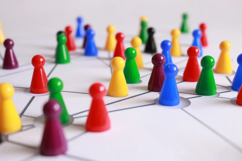 Colorful game pieces placed on a table, symbolizing leadership, strategy, planning, and structured consultancy approaches.