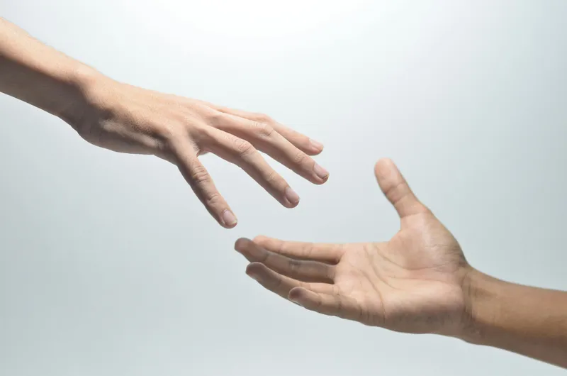 Two hands almost touching, symbolizing connection, support, and human care at Vita Integrative.